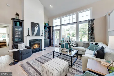 a living room with furniture large window and a fireplace