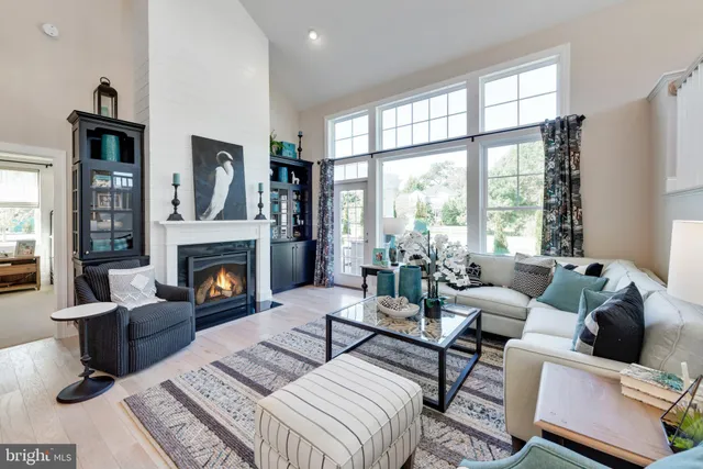 a living room with furniture large window and a fireplace