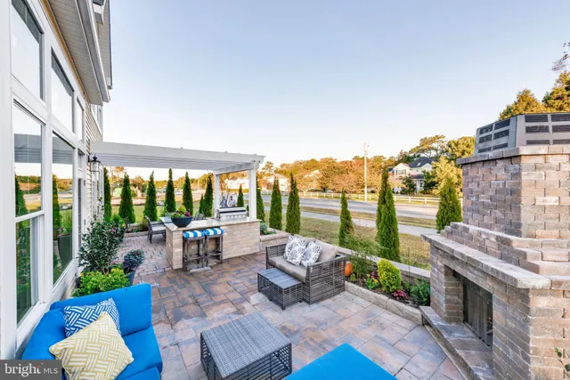 a living room with fireplace furniture and a floor to ceiling window