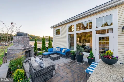 a view of a patio with couches chairs and potted plants