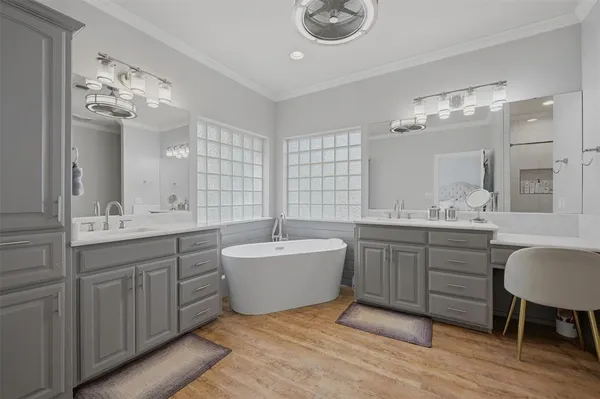 a bathroom with a tub a toilet and a shower