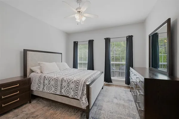 a spacious bedroom with a bed and a chandelier