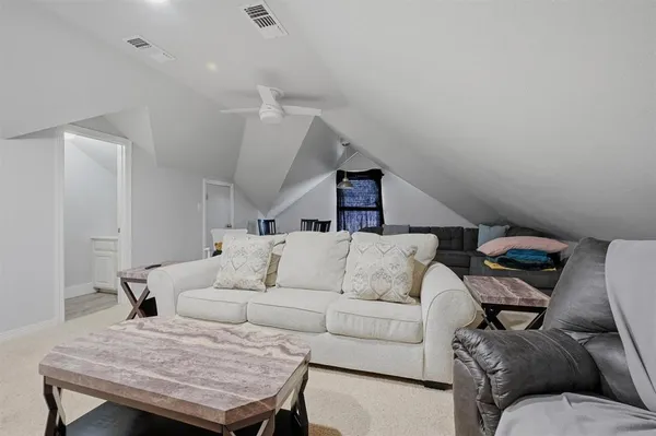 a bed room with two beds and a ceiling fan