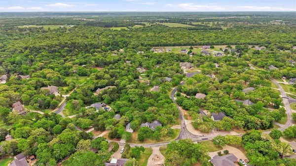 an aerial view of a houses with a lake view