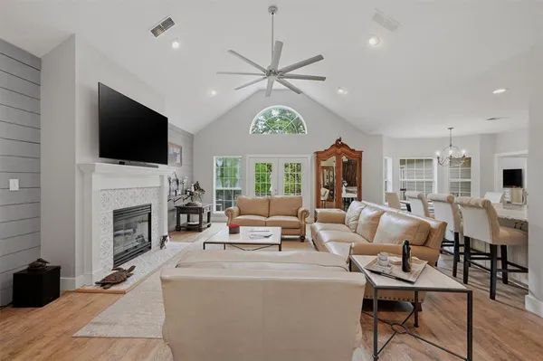 a living room with fireplace furniture and a flat screen tv