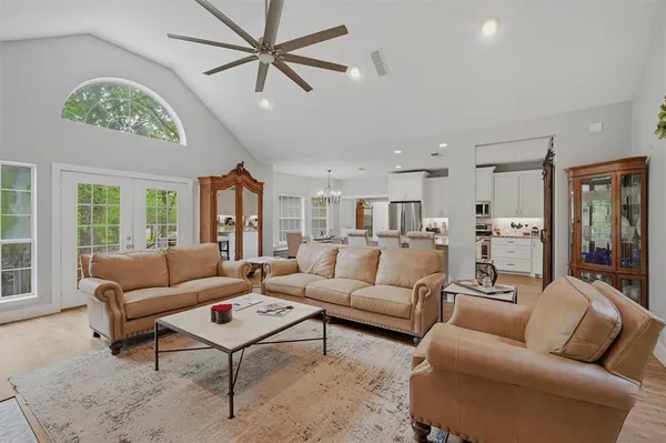 a living room with furniture ceiling fan and a window