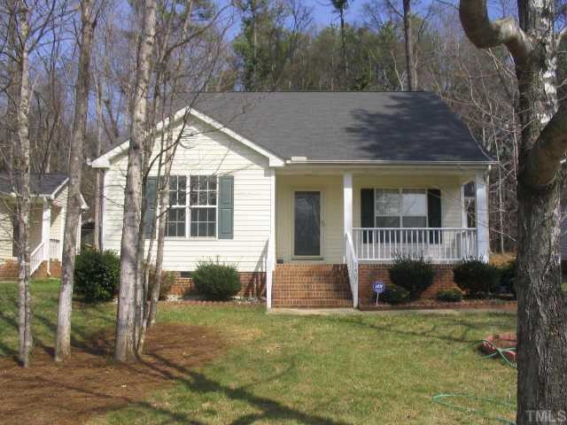 1407 Lenoir Street Raleigh, NC 27610 - Photo 3 of 5 a backyard of a house with potted plants and large tree