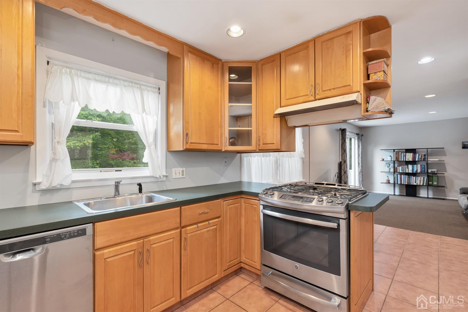1 Greenwich Road Edison, NJ 08820 - Photo 8 of 26 a kitchen with stainless steel appliances granite countertop a sink stove and cabinets