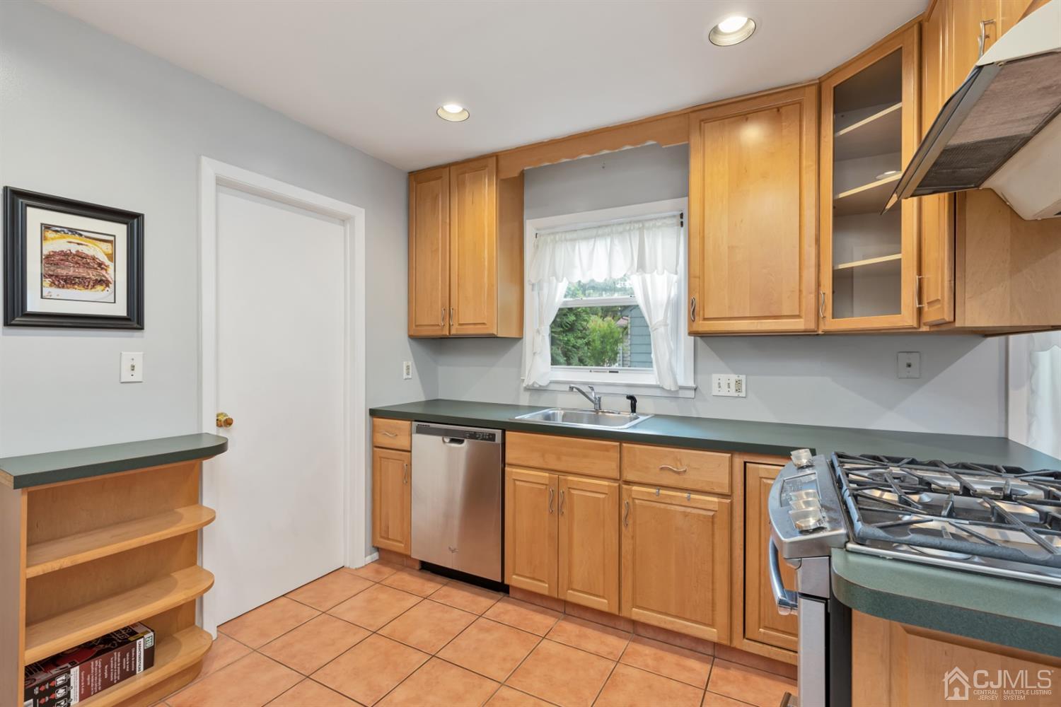 1 Greenwich Road Edison, NJ 08820 - Photo 9 of 26 a kitchen with stainless steel appliances granite countertop a stove a sink and a microwave
