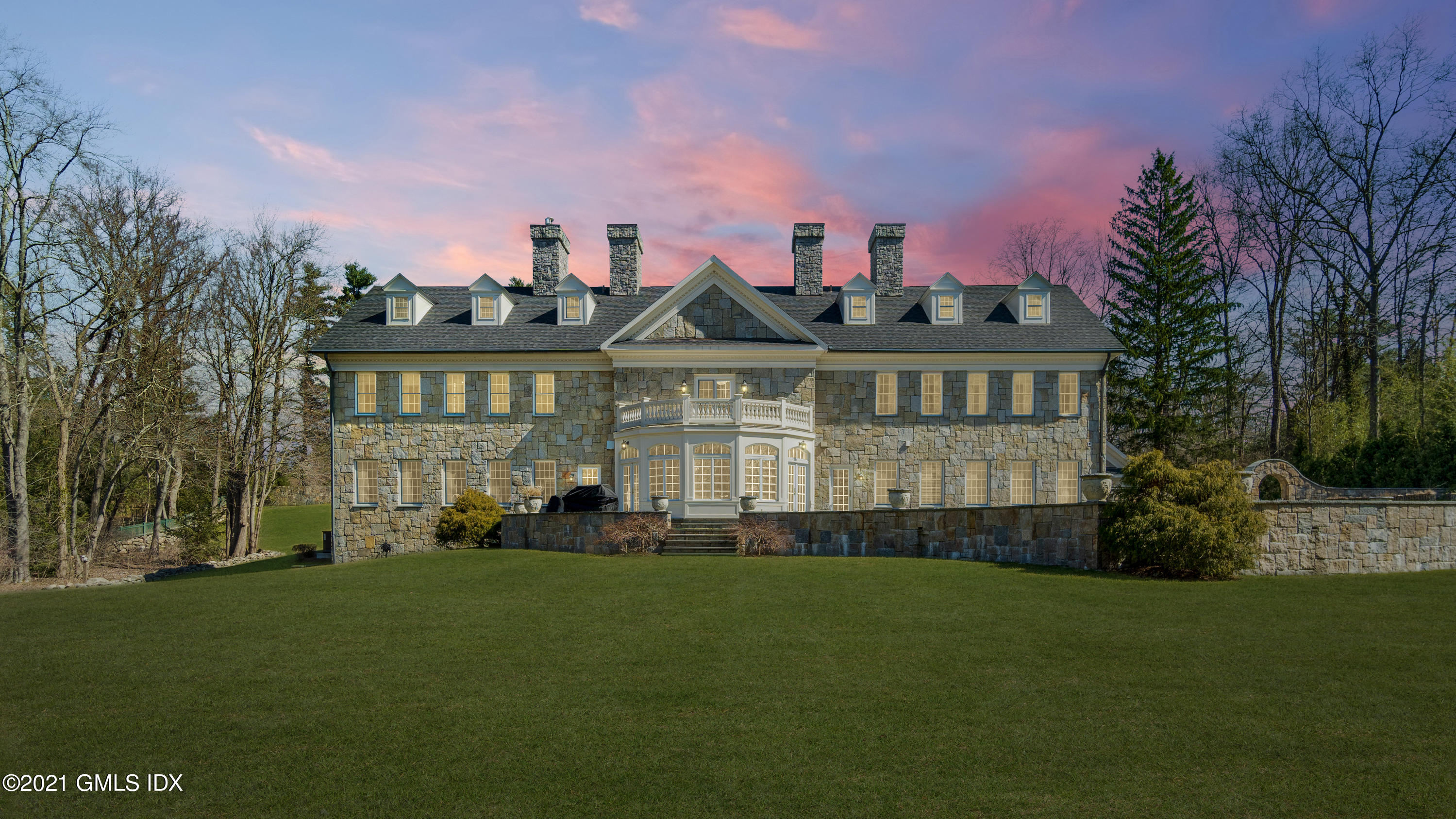 28 Dairy Road Greenwich, CT 06830 - Photo 2 of 23 a front view of a house with a garden