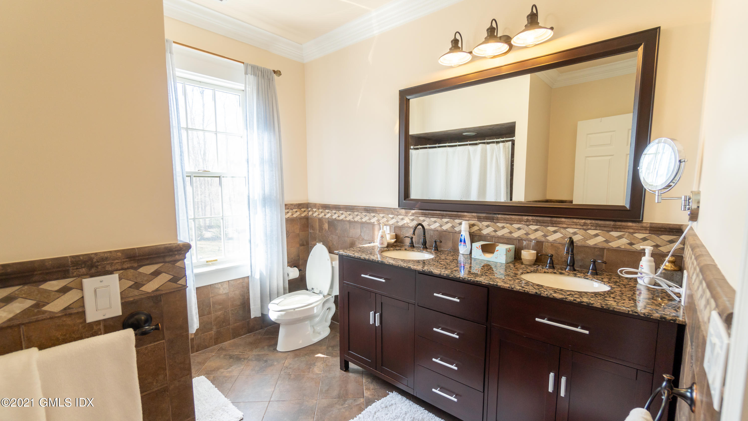 28 Dairy Road Greenwich, CT 06830 - Photo 21 of 23 a bathroom with a double vanity sink toilet and a mirror