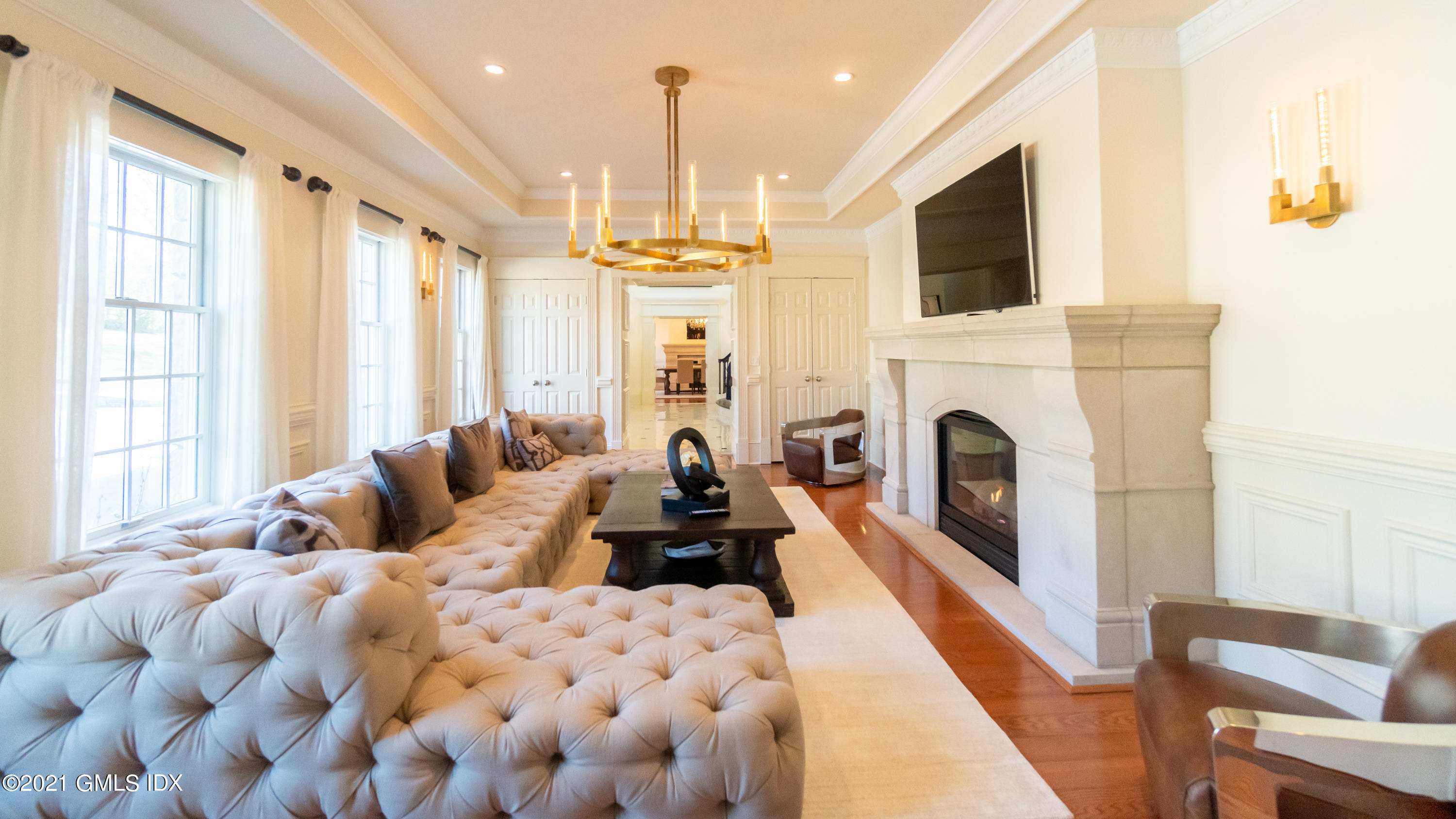 28 Dairy Road Greenwich, CT 06830 - Photo 10 of 23 a living room with furniture a fireplace and a flat screen tv