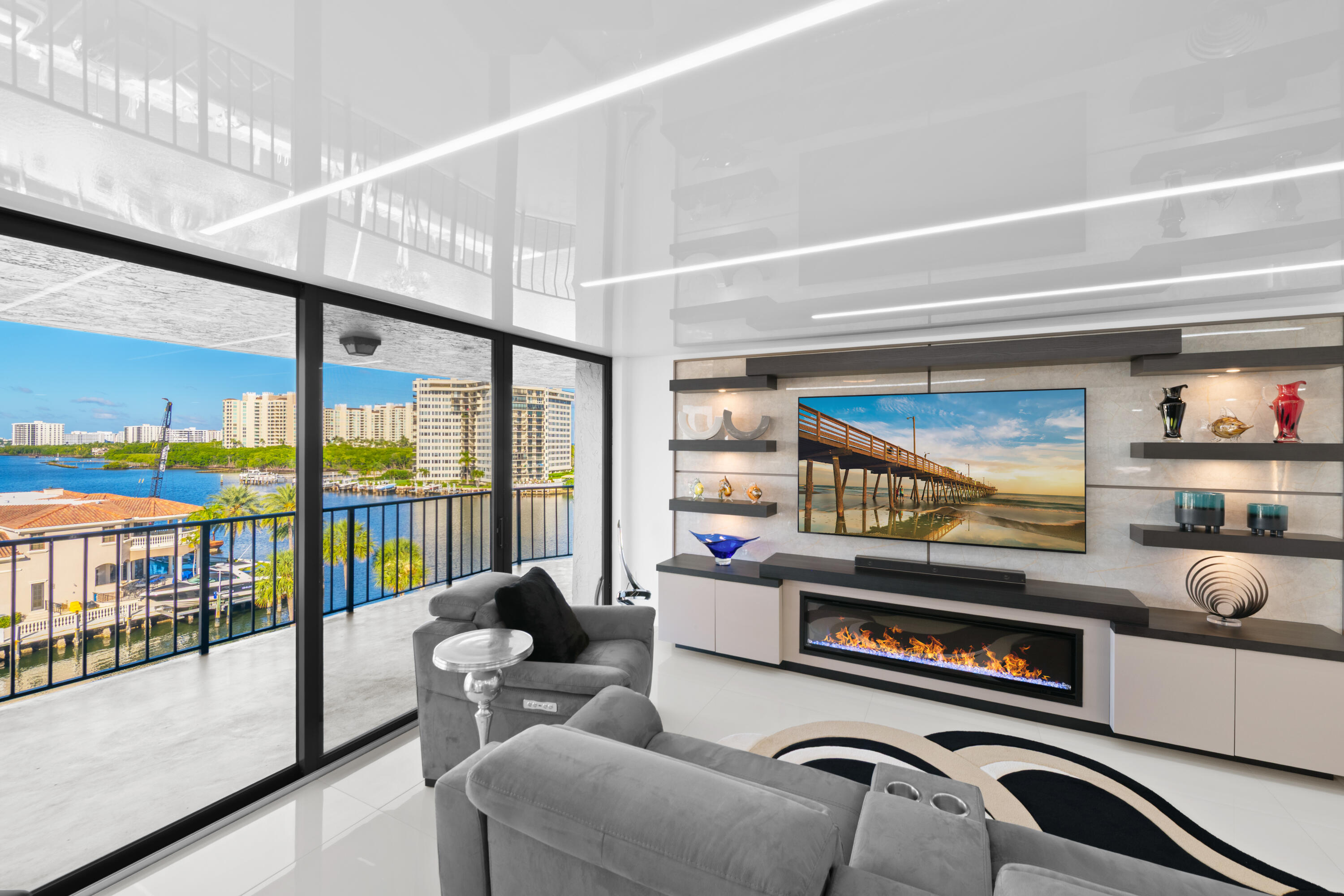 a living room with furniture a rug and a floor to ceiling window