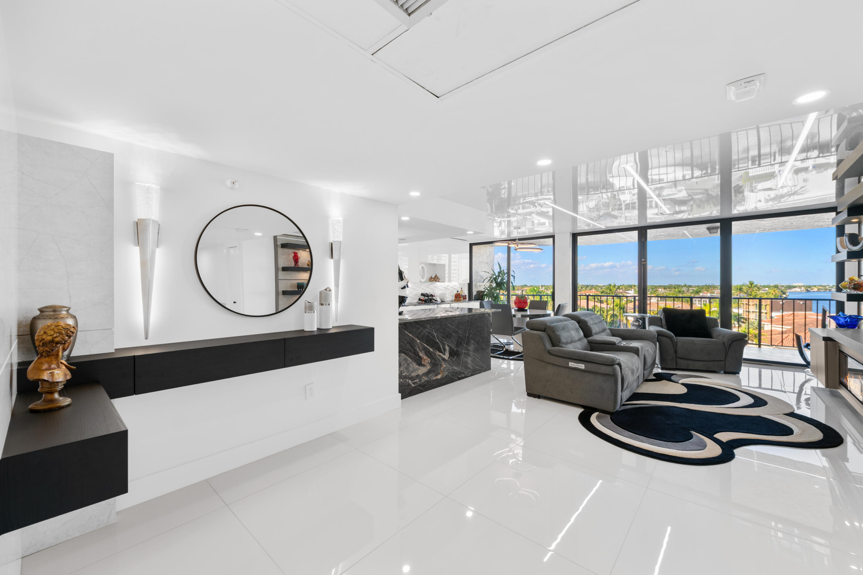 899 Jeffery Street, Unit 612 Boca Raton, FL 33487 - Photo 18 of 63 a living room with furniture a large window and a chandelier