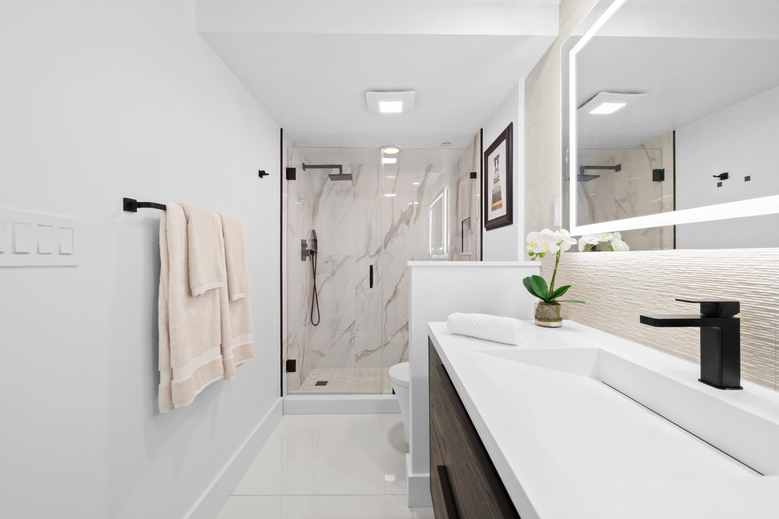 899 Jeffery Street, Unit 612 Boca Raton, FL 33487 - Photo 31 of 63 a spacious bathroom with a granite countertop sink a shower and a mirror