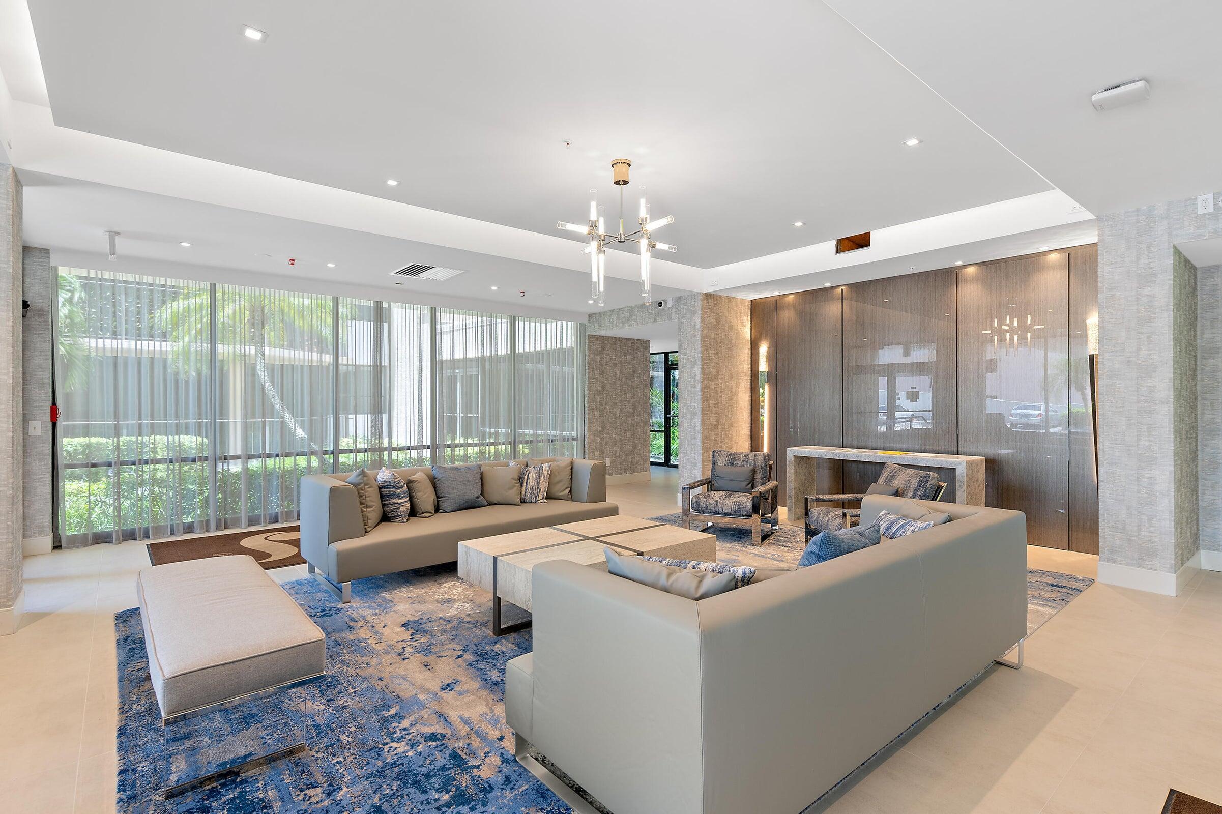 899 Jeffery Street, Unit 612 Boca Raton, FL 33487 - Photo 36 of 63 a living room with furniture and a chandelier