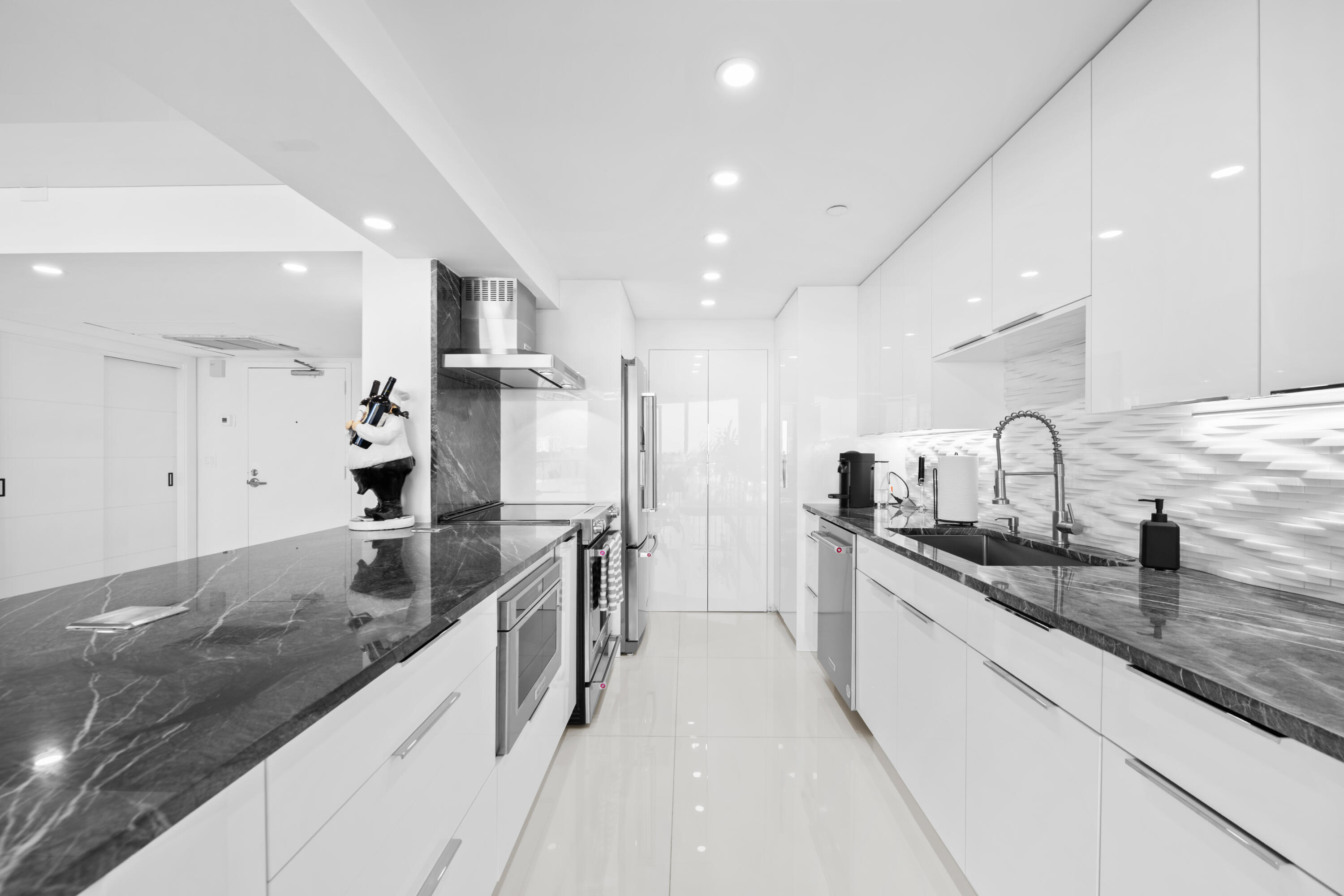 899 Jeffery Street, Unit 612 Boca Raton, FL 33487 - Photo 5 of 63 a large kitchen with stainless steel appliances a sink and a refrigerator