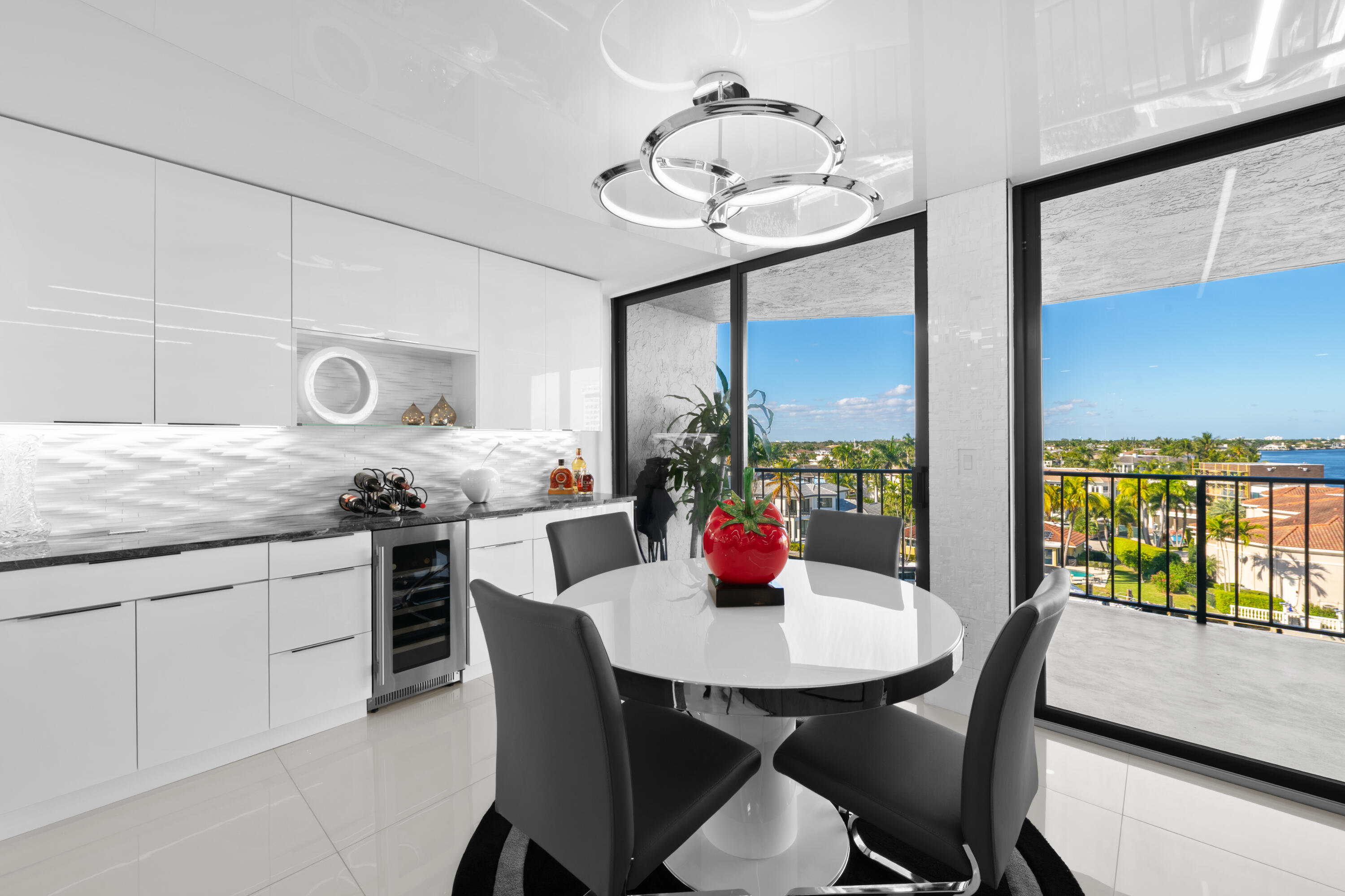 899 Jeffery Street, Unit 612 Boca Raton, FL 33487 - Photo 10 of 63 a kitchen with stainless steel appliances granite countertop a dining table and chairs