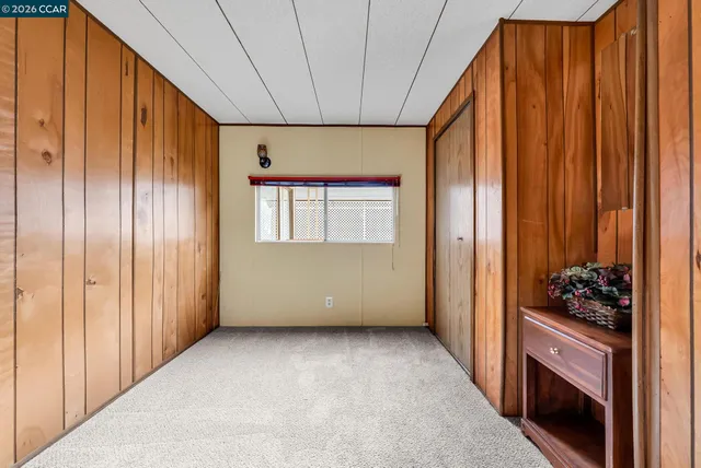 a view of a room with a window and front door