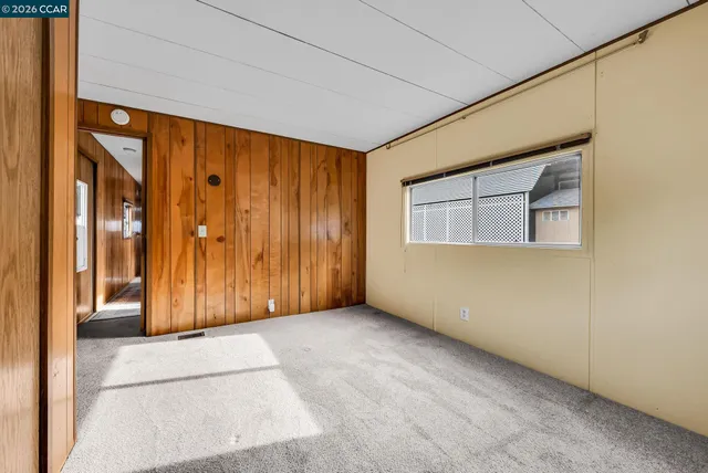 a view of two chairs in the backyard with wooden fence