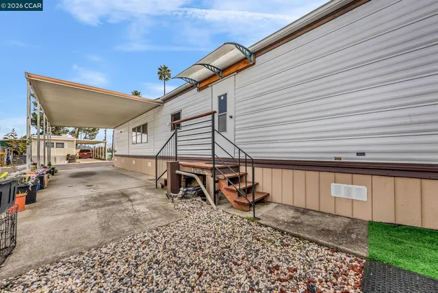a view of a house with backyard and a chair