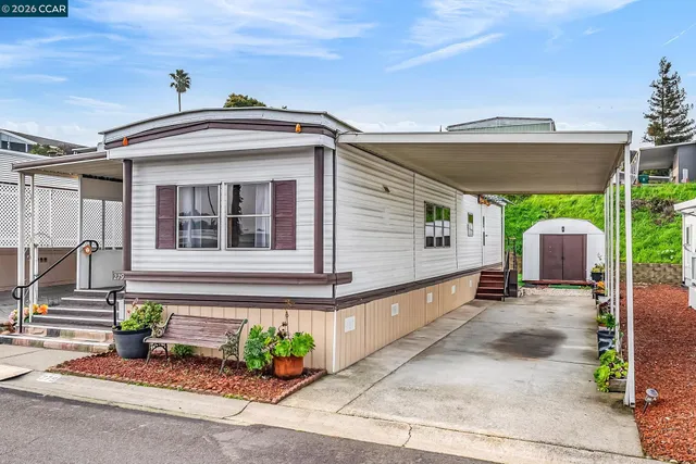 a front view of a house with potted plants