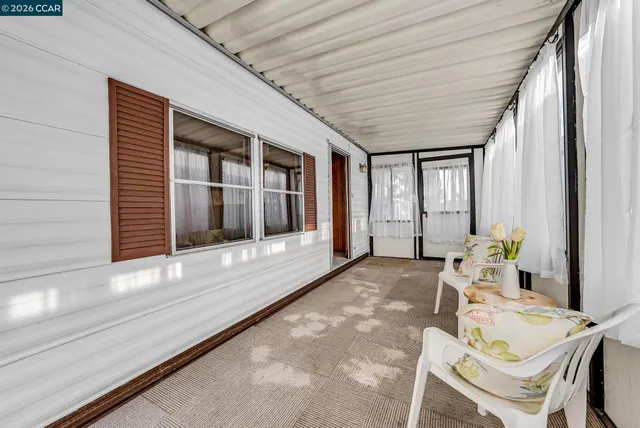 a living room with furniture and large windows