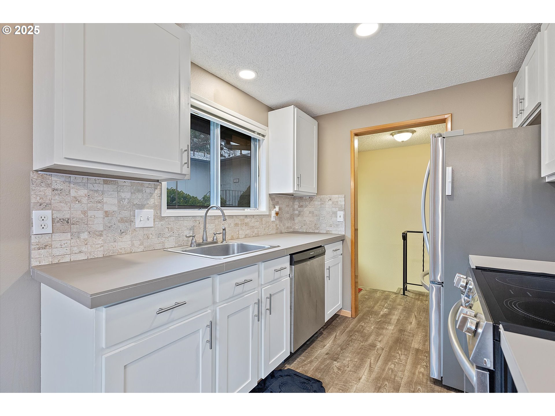 1295 Northwest Riverview Avenue Gresham, OR 97030 - Photo 14 of 35 a kitchen with a sink cabinets and a wooden floor