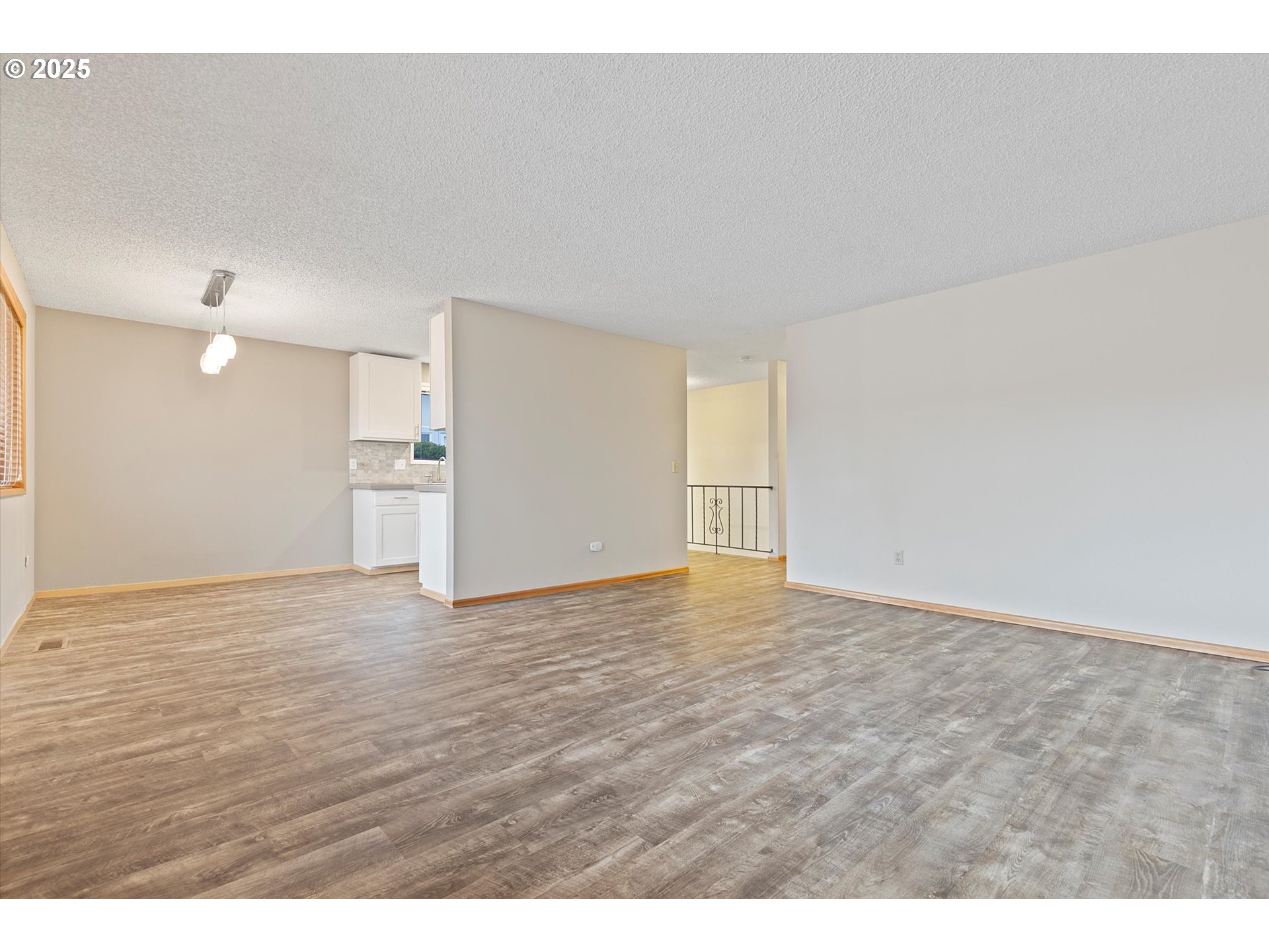 1295 Northwest Riverview Avenue Gresham, OR 97030 - Photo 9 of 35 a view of an empty room with wooden floor
