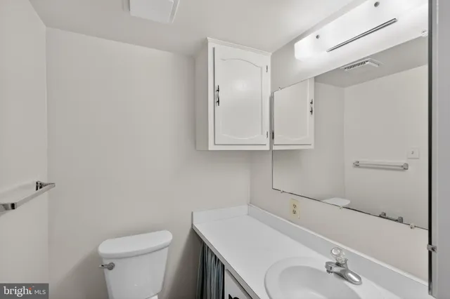 a bathroom with a tub shower sink vanity and a mirror