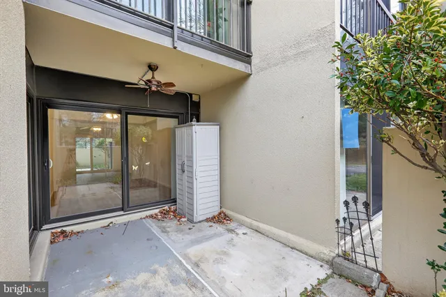 a view of a patio with a table and chairs and potted plants