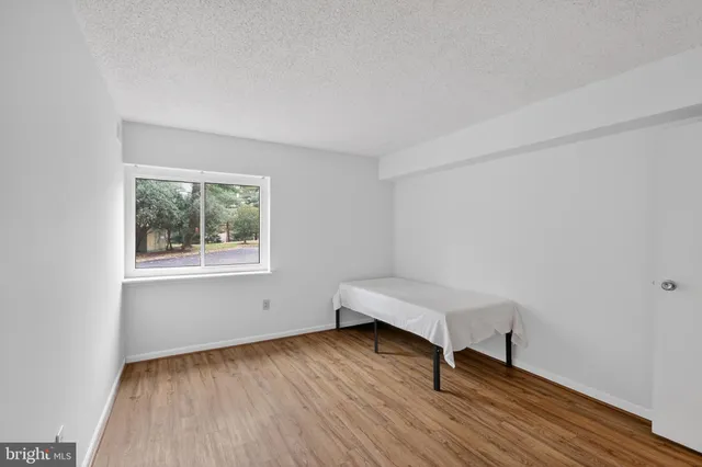 a view of a room with wooden floor and windows
