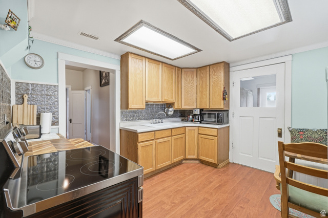 5264 West 5500th Street South Hooper, UT 84315 - Photo 8 of 38 Kitchen featuring wood-finish flooring, natural wood cabinetry, a white countertop, and a pressed tin-look backsplash