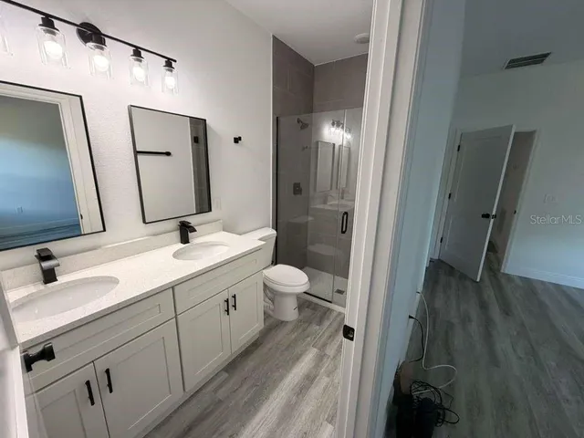 a bathroom with a double vanity sink and a mirror
