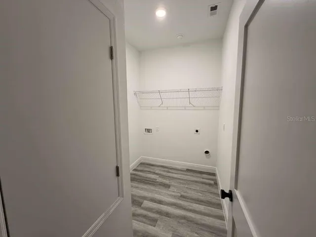 a view of walk in closet with empty racks
