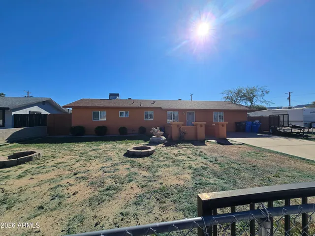 a backyard of a house with barbeque oven