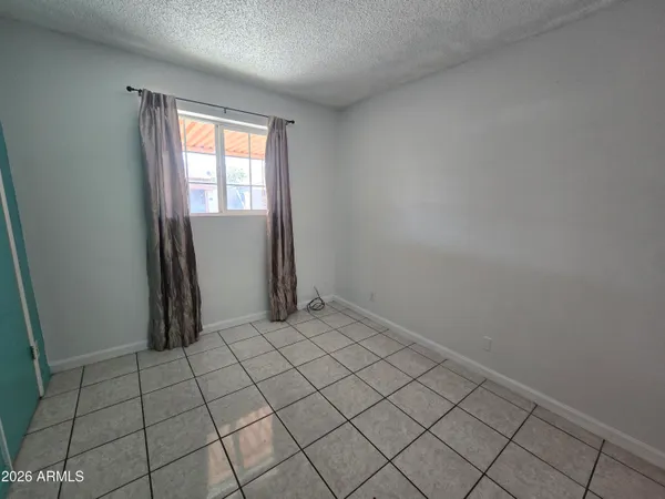 a bathroom with a granite countertop sink toilet a mirror and shower