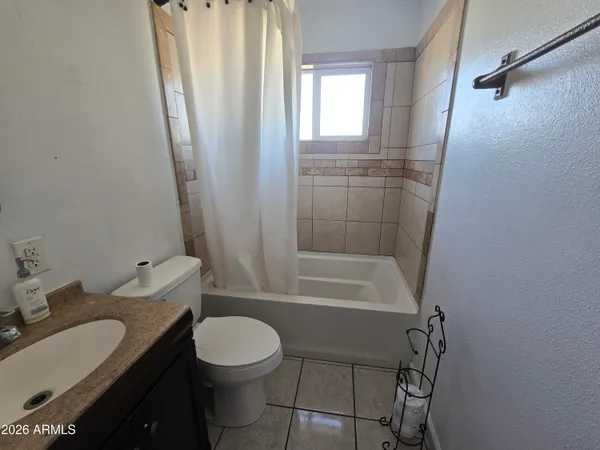 a bathroom with a sink vanity mirror and toilet