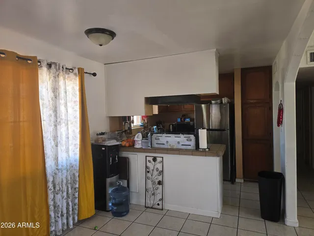 a kitchen with a refrigerator and cabinets