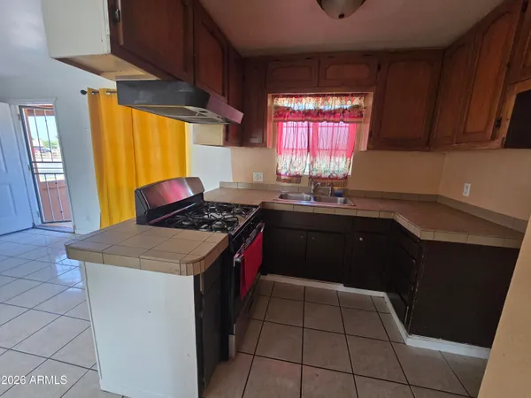 a kitchen with a sink stove and cabinets