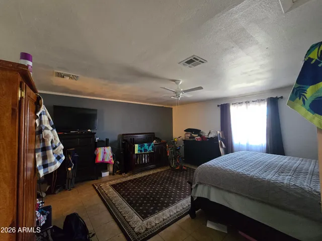 a bedroom with bed and a fireplace