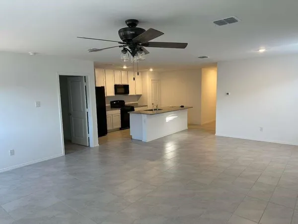 a view of a kitchen with a sink and stainless steel appliances