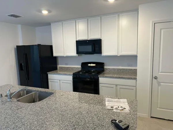 a kitchen with a refrigerator and a sink