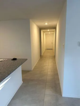 a view of hallway with kitchen