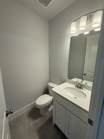 a bathroom with a sink toilet and vanity