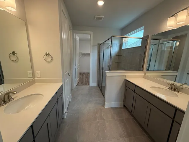 a bathroom with a sink and mirror with toilet