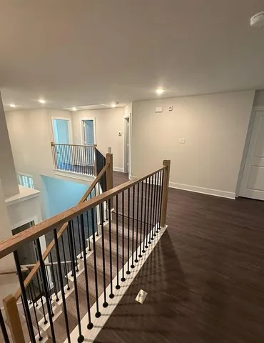 a view of a room with wooden floor