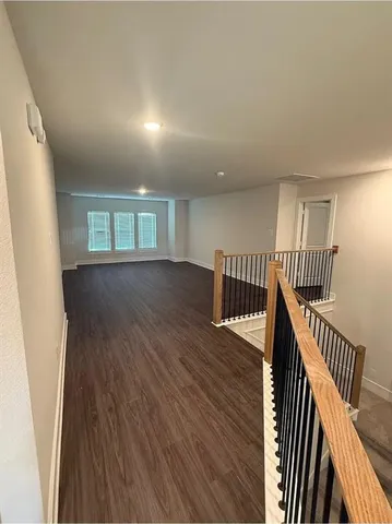 a bathroom with a granite countertop sink a toilet and tub