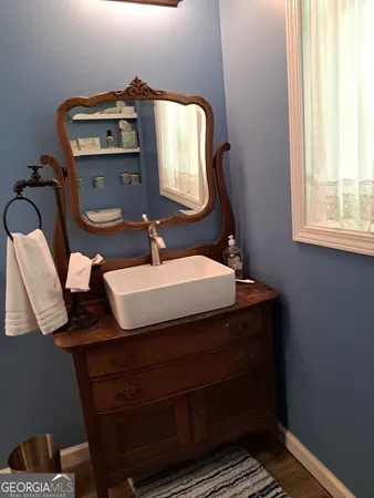 a bathroom with a sink vanity and mirror