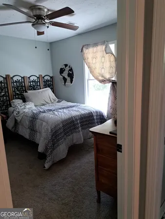 a bedroom with a bed and window
